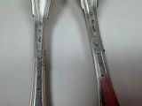 two spoons and a fork sitting on a table