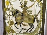 a green and gold scarf with a woman riding on a horse