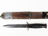two knives are laying next to each other on a white surface
