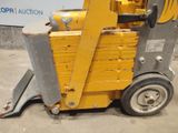a yellow forklift truck parked in a parking lot