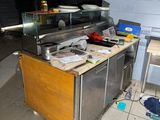 an image of a dirty kitchen with a lot of clutter on the floor
