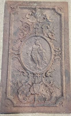 an old cast iron plaque with a bird on it