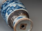 a blue and white vase sitting on a table