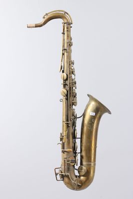 an old brass saxophone with a white background