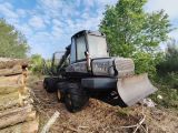 a bulldozer that is sitting in the middle of a pile of logs