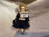 a doll that is holding a sign that says it ' s an awesome 50