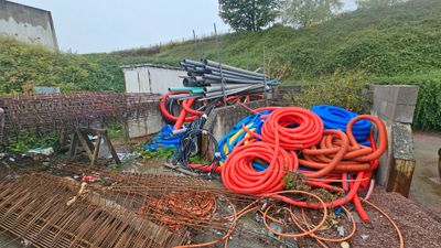 a pile of hoses sitting on top of a pile of dirt