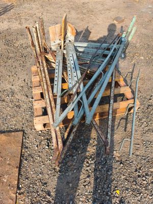 un tas de métal et de bois posé par terre à côté d'un tas de bois