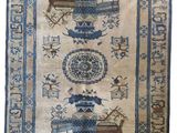 a blue and white rug with oriental designs on it