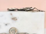 a marble block with a bunch of coins on it