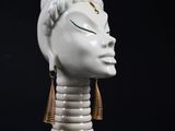 an image of a statue of a woman ' s head on a black surface
