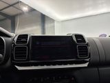 the dashboard of a car with a digital display in the center of it