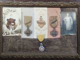 a picture of a framed picture of a medal and other items
