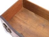 a small wooden box with handles on a white surface