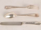 three forks and a knife on a white table