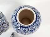 two blue and white vases sitting next to each other
