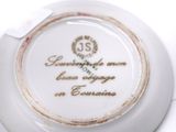a white plate with a gold and white design on it