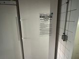 a white refrigerator in the corner of a kitchen