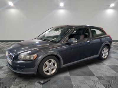 a picture of a blue volvo wagon parked in a garage