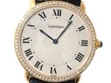 an image of a gold watch with roman numerals and diamonds