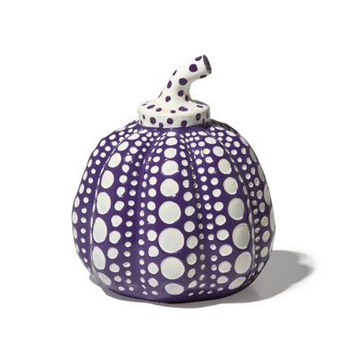 purple and white polka dot pumpkin with a dalmatian figurine on top