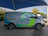 an image of a van parked under a blue umbrella
