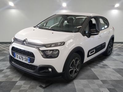 the white citrole is parked on a checkered tile floor