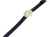 a close up of a watch on a black leather strap