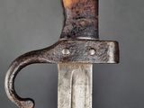 a close up of a knife with a metal handle on a gray background