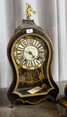 two clocks that are sitting next to each other on a table