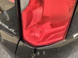 a close up of a car ' s tail light with a price tag on it