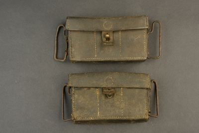 two pieces of leather are sitting on a gray surface