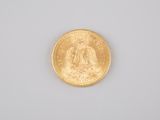 a close up of a gold coin on a white surface