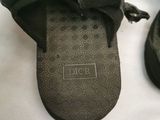 pair of black slippers on a white surface with a white background