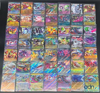 a large collection of pokemon cards sitting on top of a table