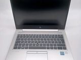 an open laptop computer sitting on top of a white table