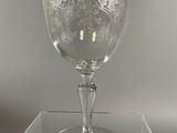 a glass with a design on it sitting on a table