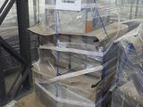 a large stack of boxes sitting on pallets in a warehouse