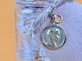 a small glass jar with a coin in it on a table