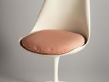 an image of a white chair with a pink cushion on it