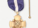a gold medal and a purple ribbon with a cross on it
