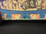 painting of a boat with animals and fish on the side