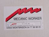 a picture of a mechanic ' s sign on the side of a building