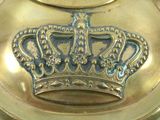 a gold plate with a crown on top of it