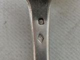 a silver spoon with a spoon handle on a table