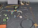 several pieces of jewelry sitting on top of a table next to a book