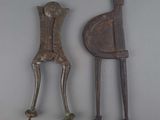 two metal objects that are sitting on a white surface