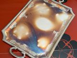 a picture of a silver tray on a red table