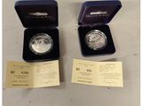 a couple of silver coins in a blue box on top of a table