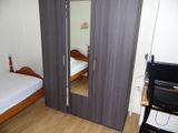 a bedroom with two beds and a mirror on the wall